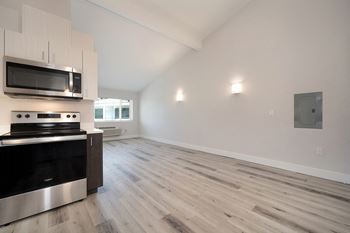 an empty kitchen and living room with white walls and wood flooring  at Track 281 Apartments, Sacramento, 95811